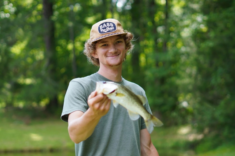 camper holding a fish he caught