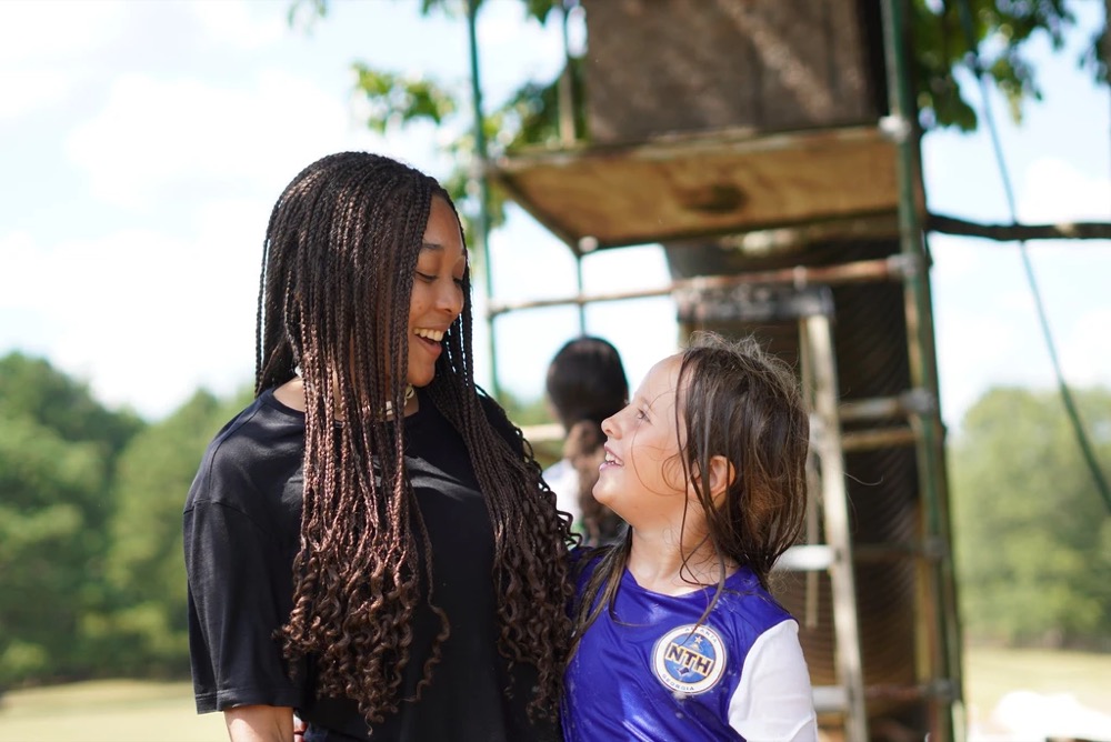counselor and camper laughing together